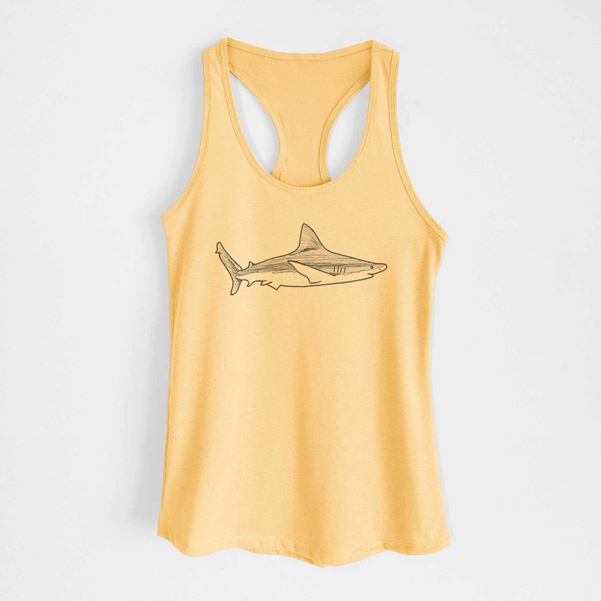 Banana cream women's racerback tank top laid flat, printed with a black ink illustration of a silvertip shark swimming in profile.
