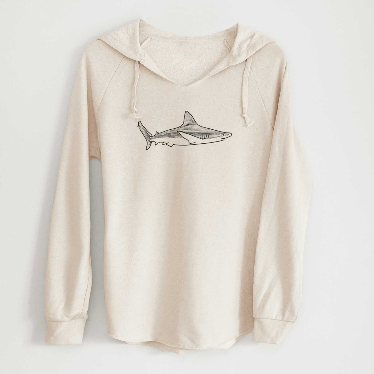 Bone cream women's Cali Wave hooded sweatshirt laid flat, printed with a black ink illustration of a silvertip shark swimming in profile.