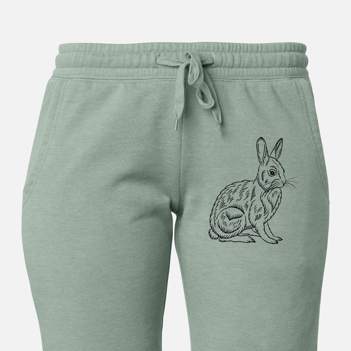 Front of sage green Cali Wave sweatpants, printed with a detailed black ink illustration of a snowshoe hare sitting upright on the leg.