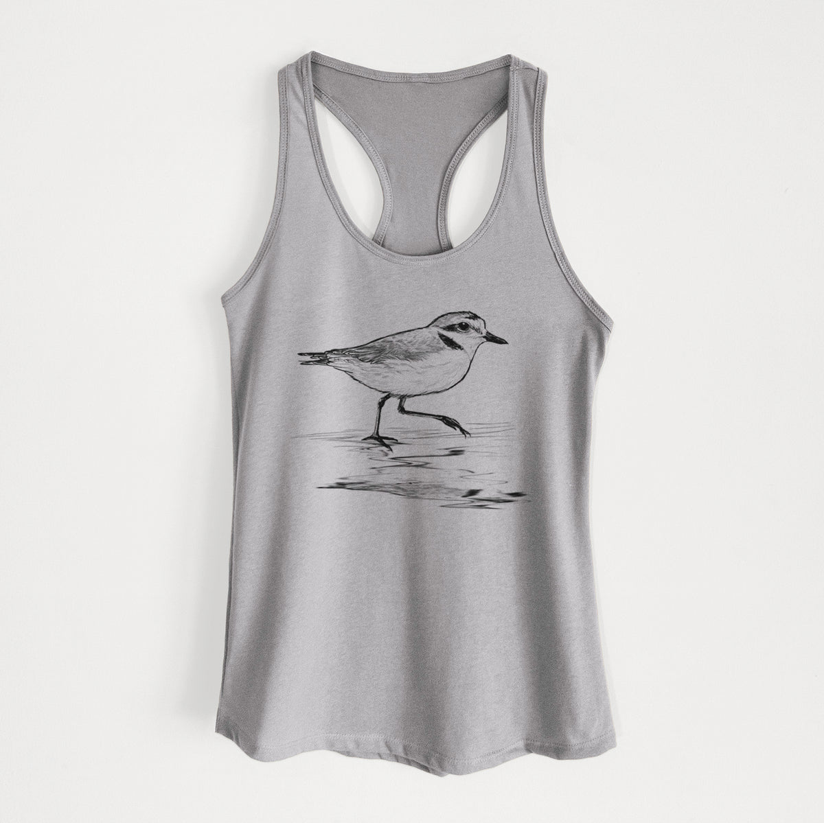 Heather grey women's racerback tank top laid flat, printed with a black ink sketch of a snowy plover running along the wet shoreline.