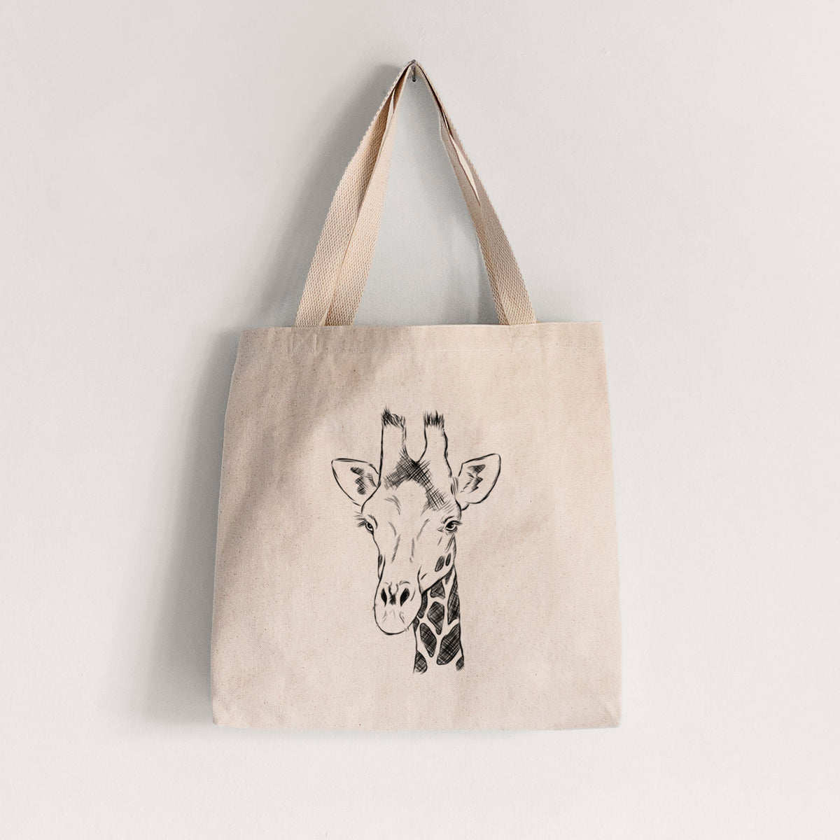 Natural canvas tote bag printed with a black ink portrait of a southern giraffe's head and neck.
