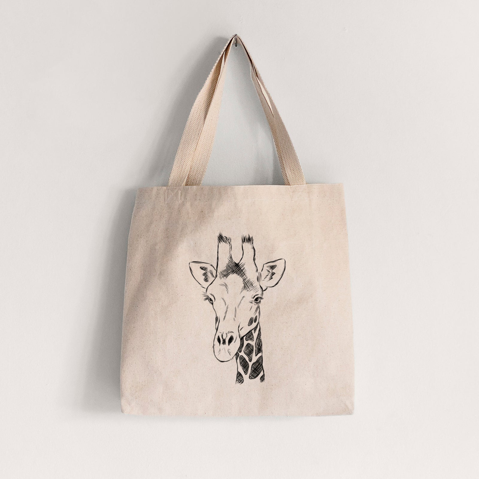 Natural canvas tote bag printed with a black ink portrait of a southern giraffe's head and neck.