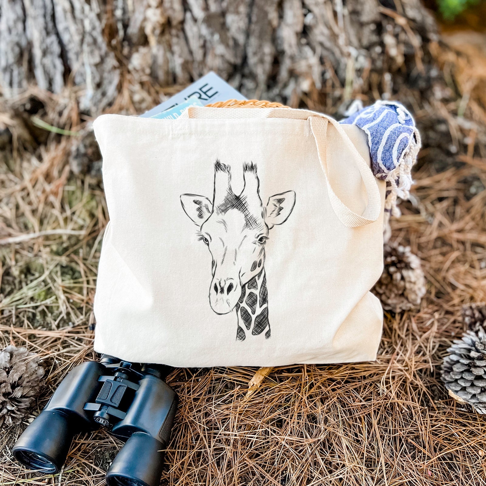 Natural canvas tote bag printed with a black ink portrait of a southern giraffe's head and neck.