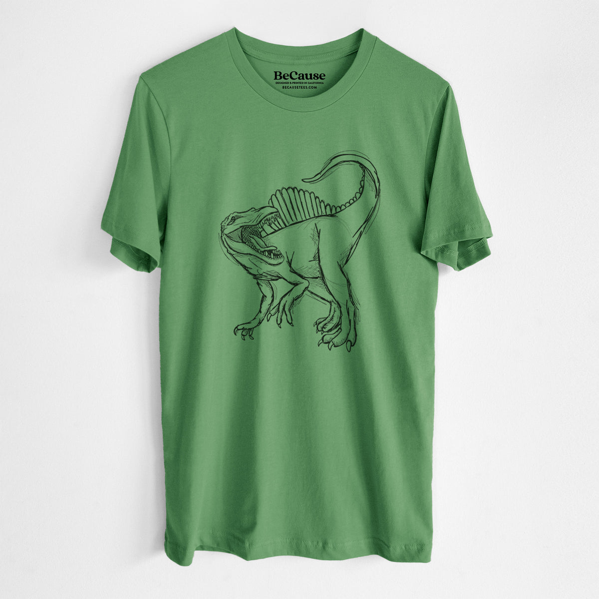Leaf green lightweight cotton t-shirt laid flat, printed with a black ink illustration of a Spinosaurus with its tall sail-shaped back.