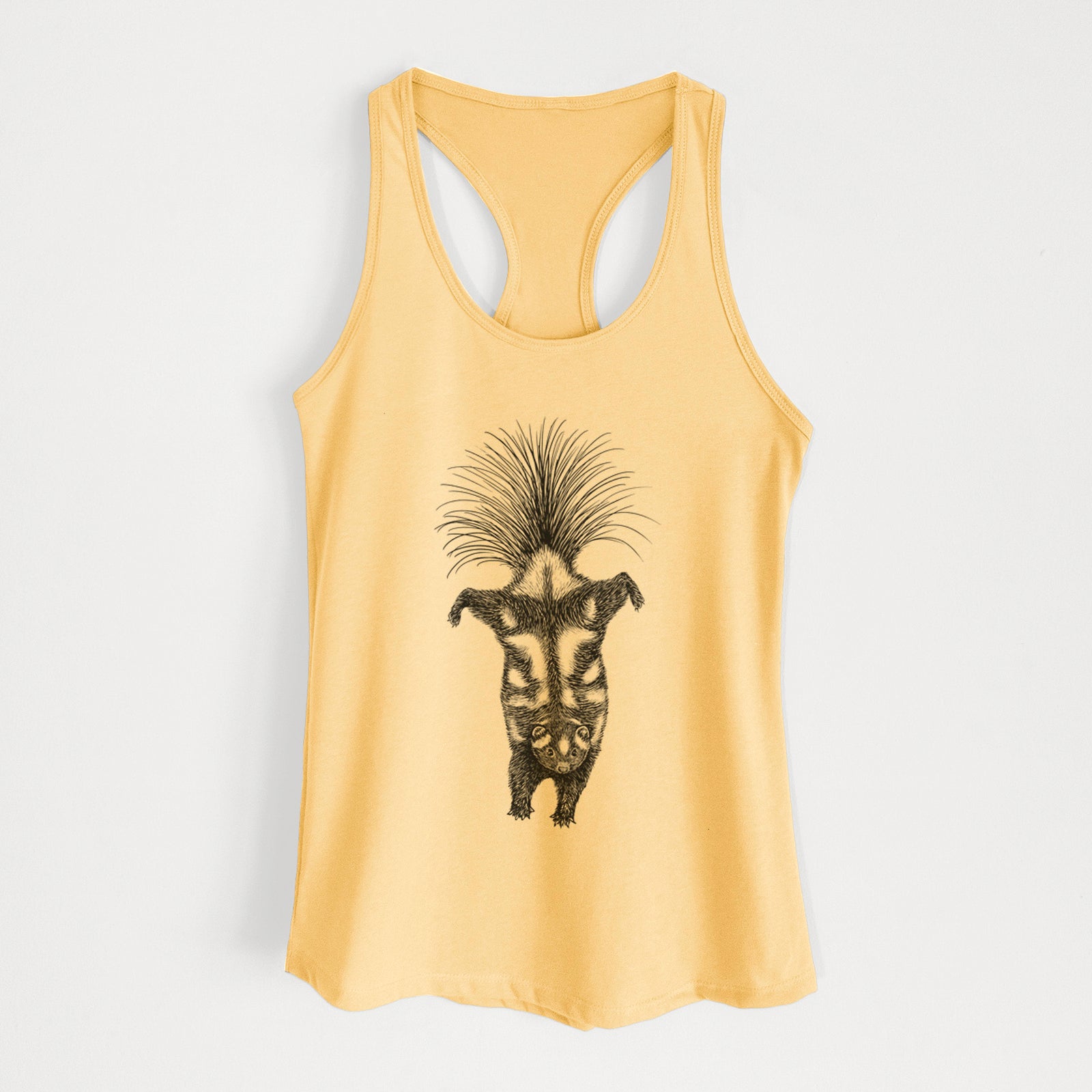 Banana cream women's racerback tank top laid flat, printed with a black ink illustration of a spotted skunk doing a handstand with its tail fanned.