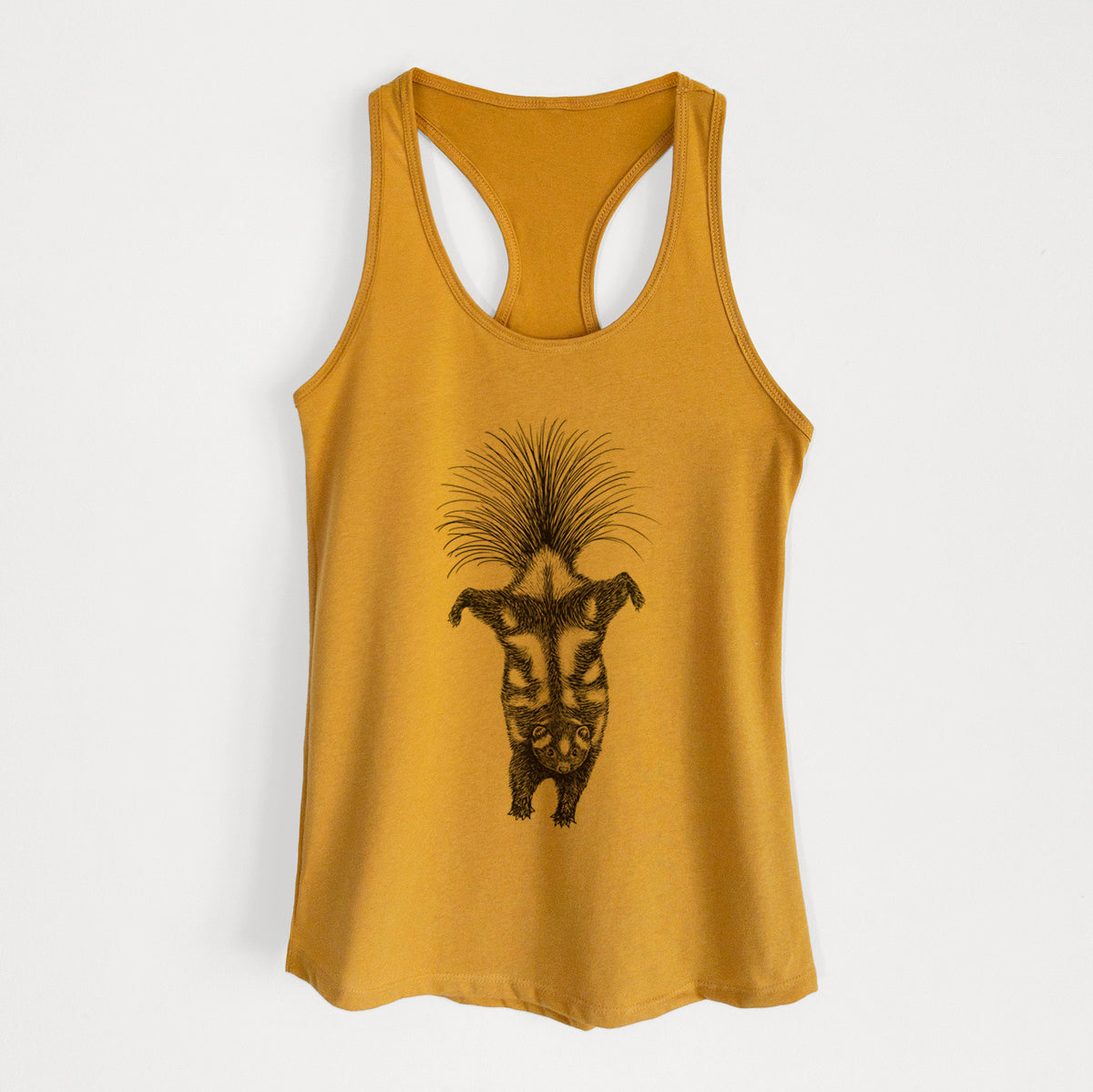 Gold women's racerback tank top laid flat, printed with a black ink illustration of a spotted skunk doing a handstand with its tail fanned.