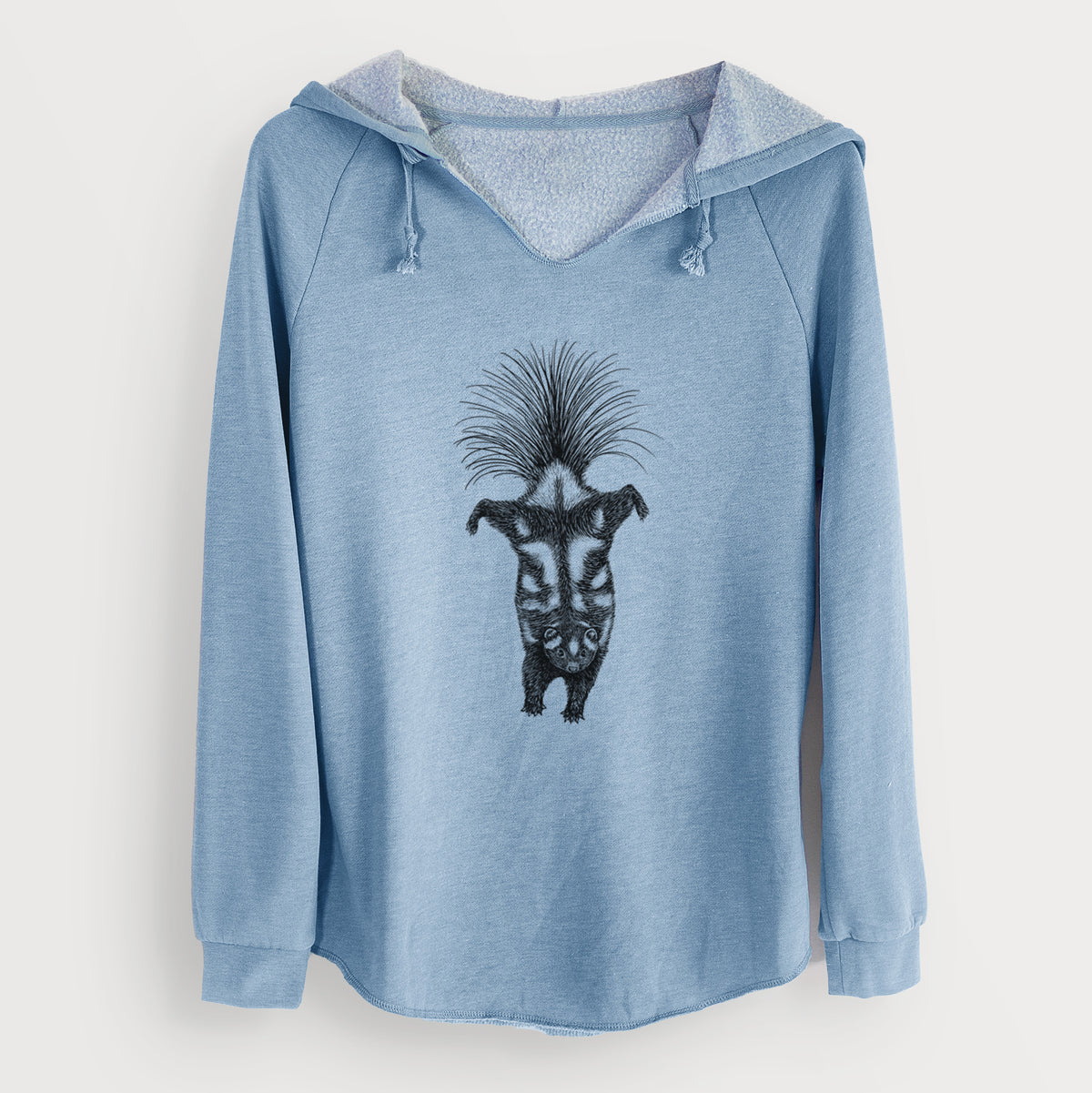 Misty blue women's Cali Wave hooded sweatshirt laid flat, printed with a black ink illustration of a spotted skunk doing a handstand with its tail fanned.