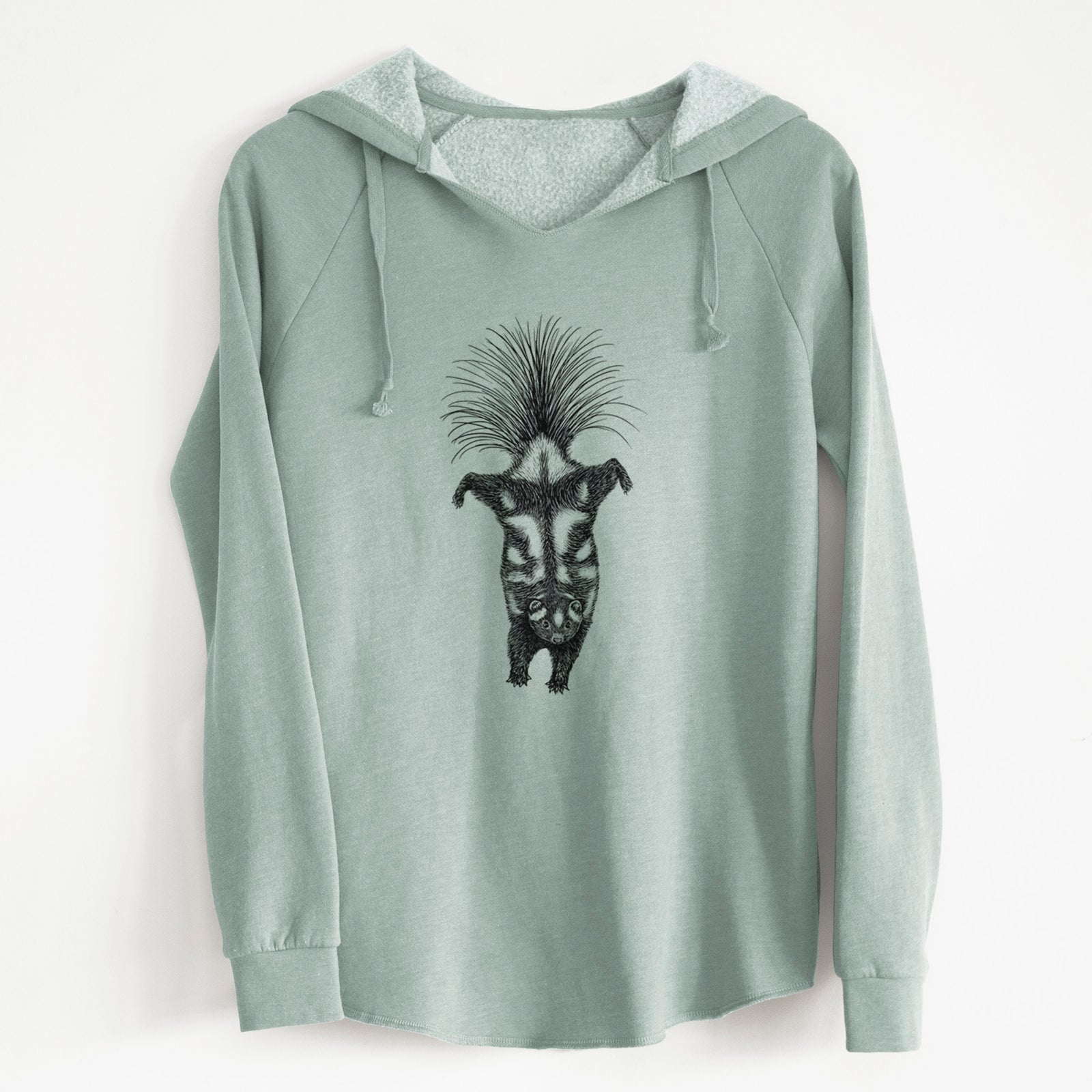 Sage green women's Cali Wave hooded sweatshirt laid flat, printed with a black ink illustration of a spotted skunk doing a handstand with its tail fanned.