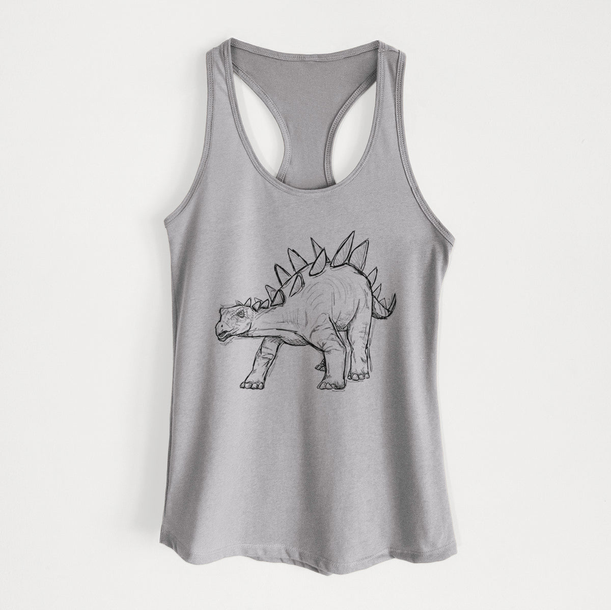 Heather grey women's racerback tank top laid flat, printed with a black ink illustration of a Stegosaurus with plates along its back.