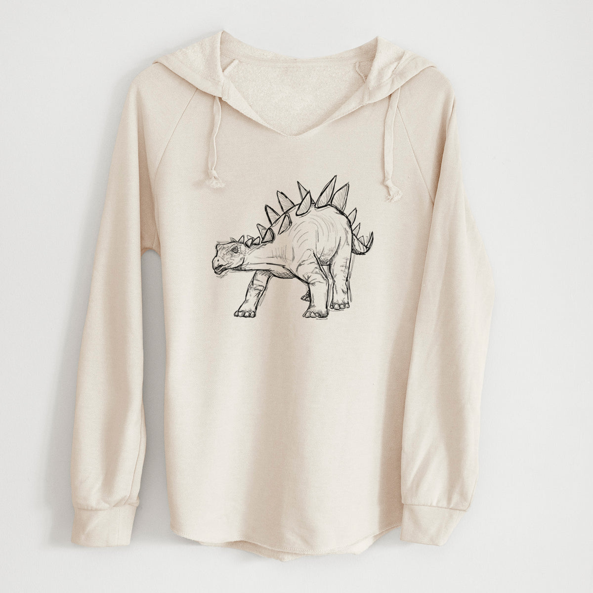 Bone cream women's Cali Wave hooded sweatshirt laid flat, printed with a black ink illustration of a Stegosaurus with plates along its back.
