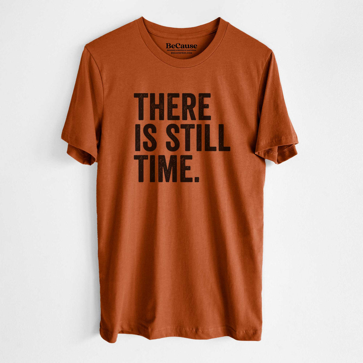Autumn lightweight cotton t-shirt laid flat, printed with bold black words reading There Is Still Time.