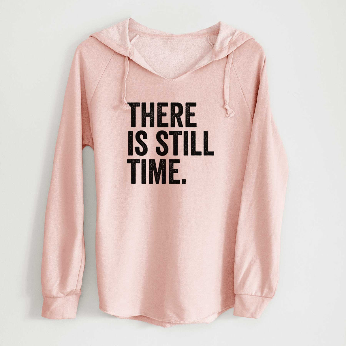Blush pink women's Cali Wave hooded sweatshirt laid flat, printed with bold black words reading There Is Still Time.