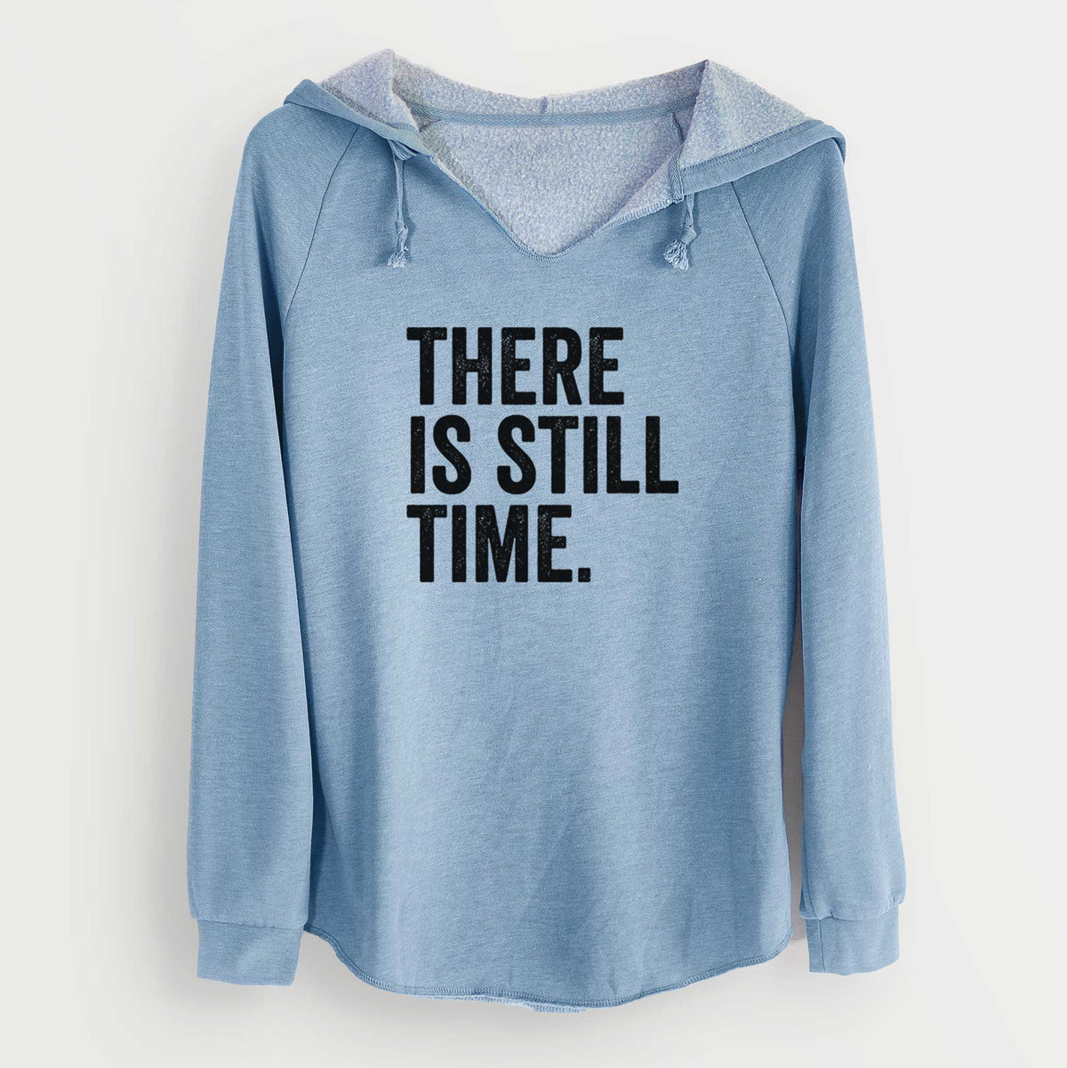Misty blue women's Cali Wave hooded sweatshirt laid flat, printed with bold black words reading There Is Still Time.