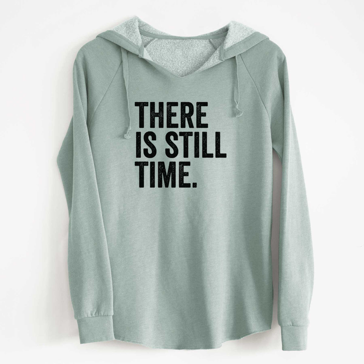 Sage green women's Cali Wave hooded sweatshirt laid flat, printed with bold black words reading There Is Still Time.