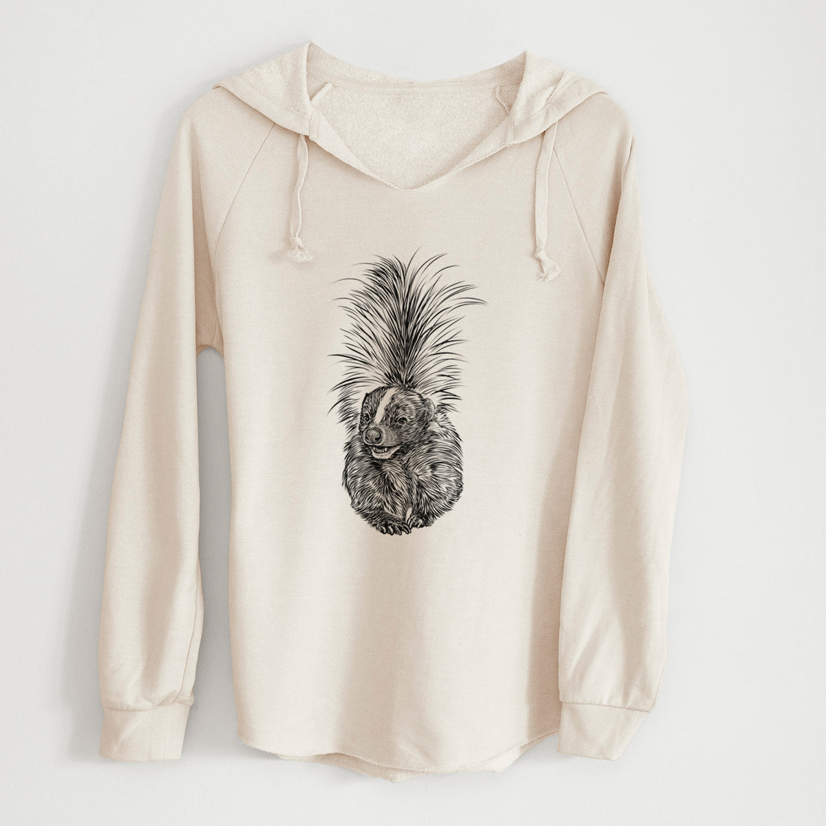 Bone cream women's Cali Wave hooded sweatshirt laid flat, printed with a detailed black ink illustration of a striped skunk with its tail raised.