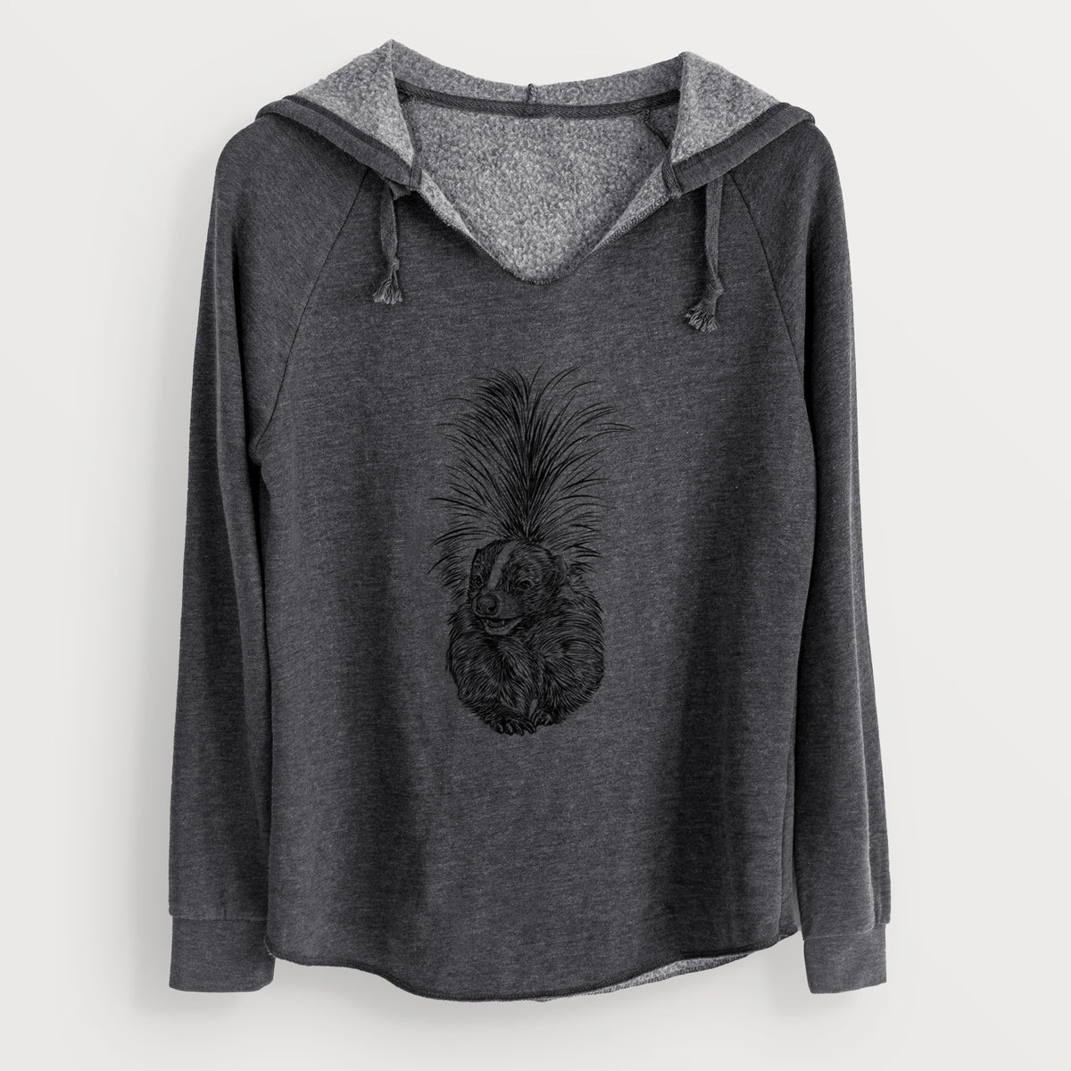 Charcoal grey women's Cali Wave hooded sweatshirt laid flat, printed with a detailed black ink illustration of a striped skunk with its tail raised.