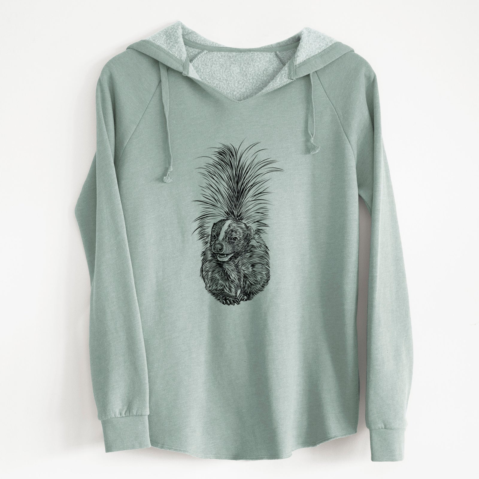 Sage green women's Cali Wave hooded sweatshirt laid flat, printed with a detailed black ink illustration of a striped skunk with its tail raised.