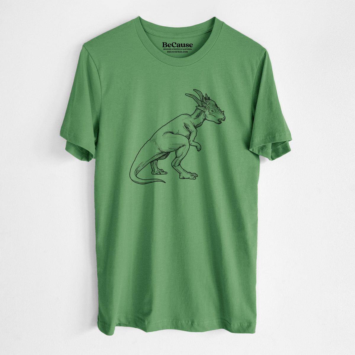 Leaf green lightweight cotton t-shirt laid flat, printed with a black ink illustration of a Stygimoloch dinosaur with a spiky domed head.
