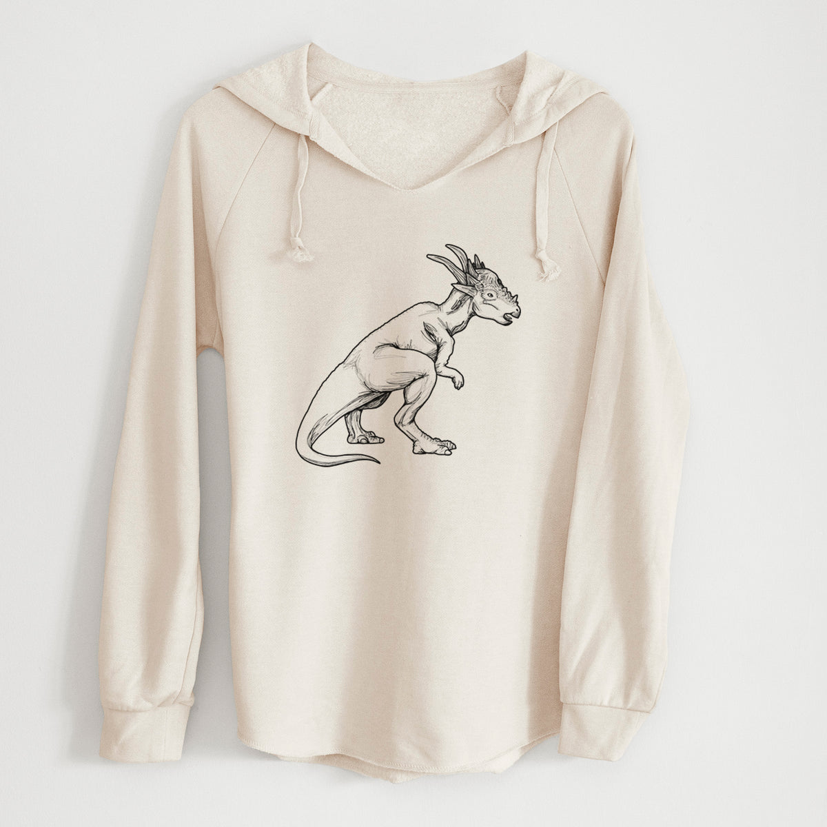 Bone cream women's Cali Wave hooded sweatshirt laid flat, printed with a black ink illustration of a Stygimoloch dinosaur with a spiky domed head.