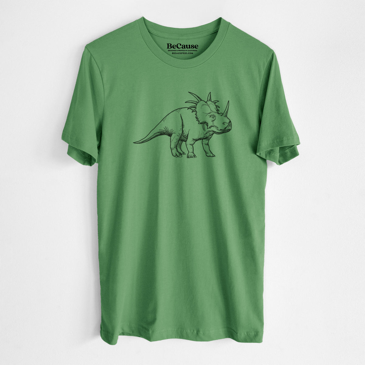 Leaf green lightweight cotton t-shirt laid flat, printed with a black ink illustration of a Styracosaurus with its spiked frill.