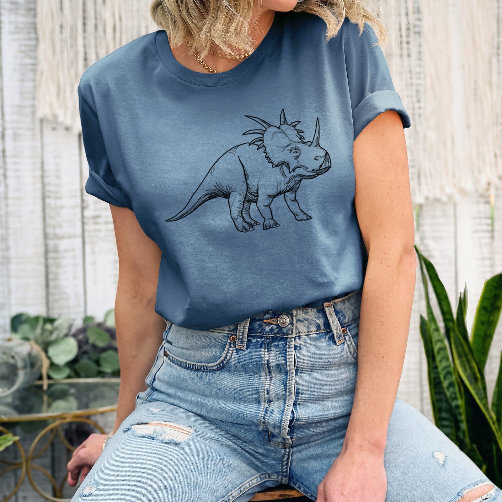 Autumn lightweight cotton t-shirt laid flat, printed with a black ink illustration of a Styracosaurus with its spiked frill.