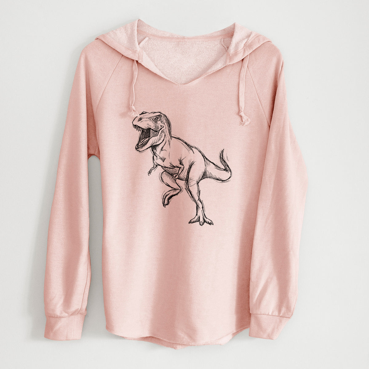 Blush pink women's Cali Wave hooded sweatshirt laid flat, printed with a black ink illustration of a Tyrannosaurus rex roaring.