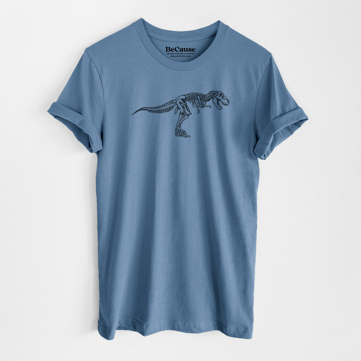 Steel blue lightweight cotton t-shirt laid flat, printed with a black ink illustration of a Tyrannosaurus rex skeleton.