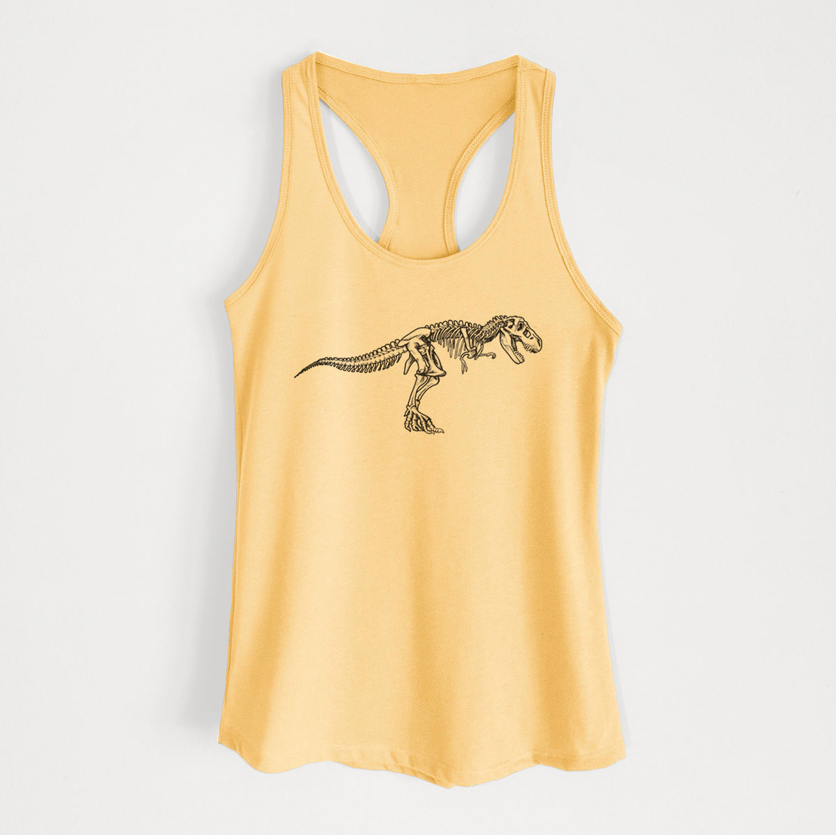Banana cream women's racerback tank top laid flat, printed with a black ink illustration of a Tyrannosaurus rex skeleton.