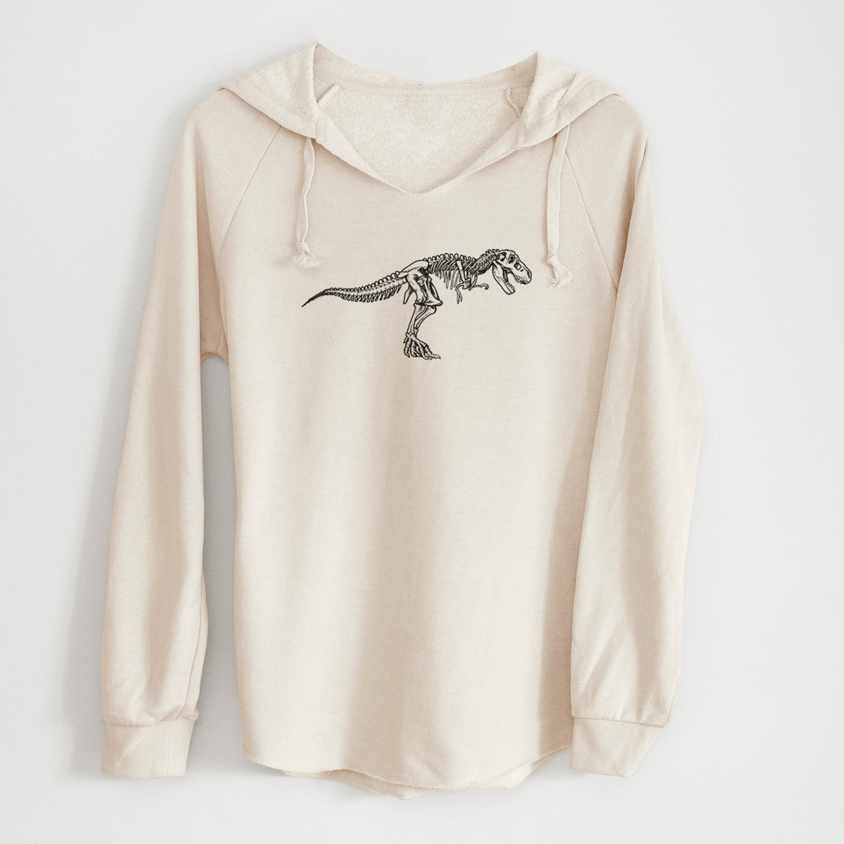 Bone cream women's Cali Wave hooded sweatshirt laid flat, printed with a black ink illustration of a Tyrannosaurus rex skeleton.
