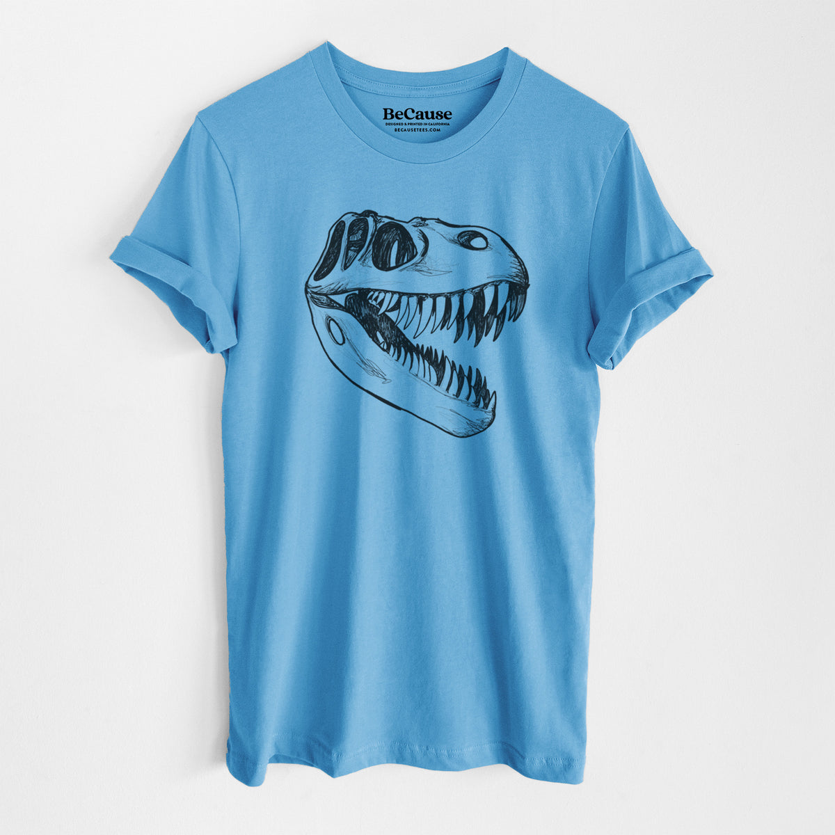 Ocean blue lightweight cotton t-shirt laid flat, printed with a black ink illustration of a Tyrannosaurus rex skull with sharp teeth.