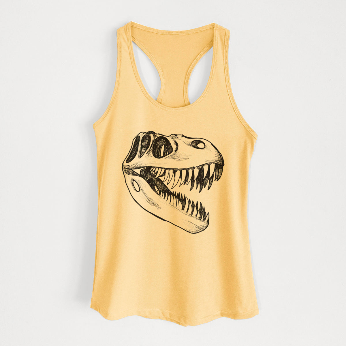 Banana cream women's racerback tank top laid flat, printed with a black ink illustration of a Tyrannosaurus rex skull with sharp teeth.