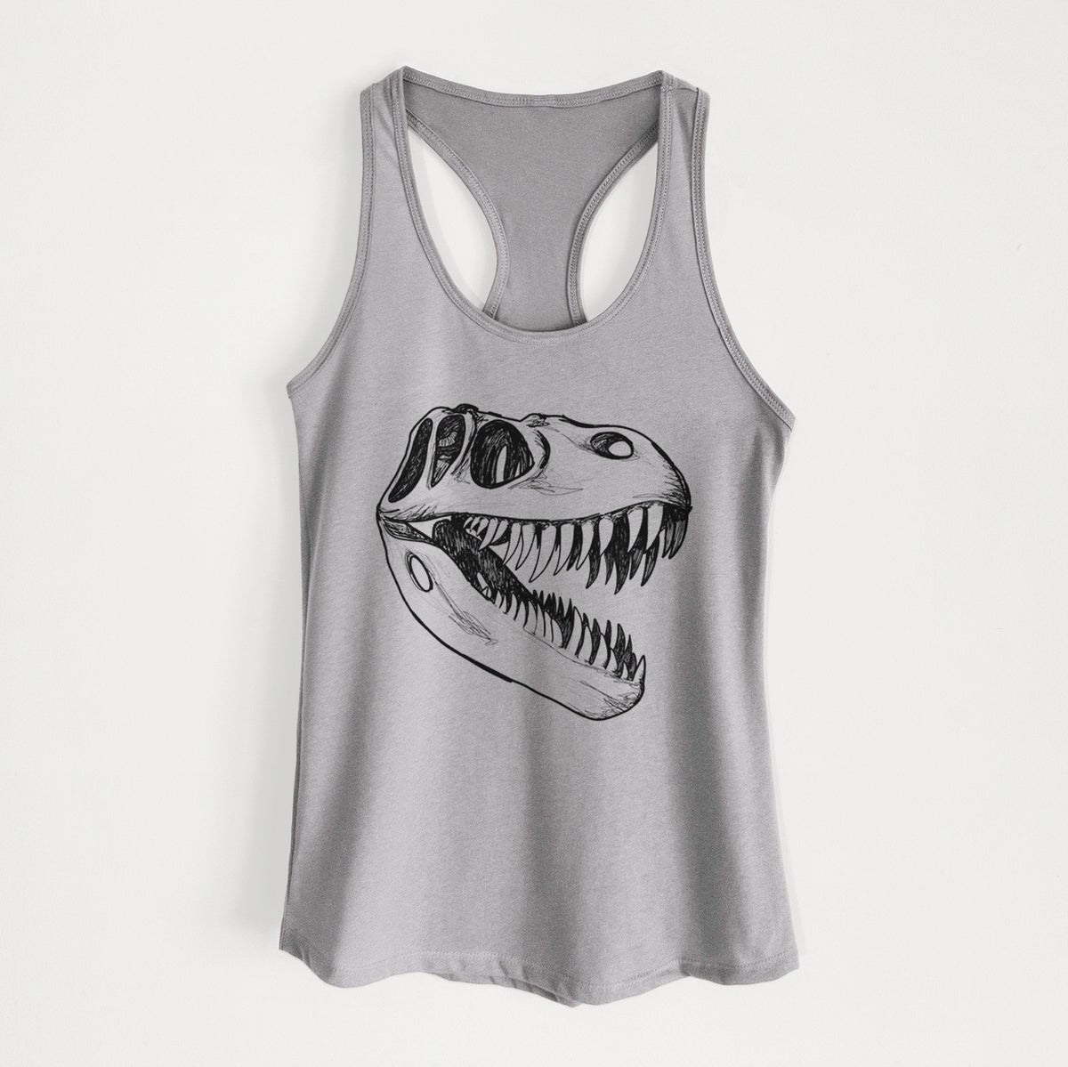 Heather grey women's racerback tank top laid flat, printed with a black ink illustration of a Tyrannosaurus rex skull with sharp teeth.