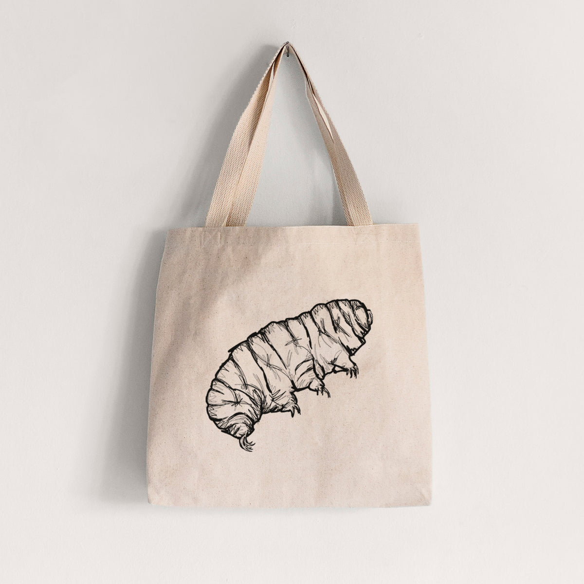 Natural canvas tote bag printed with a detailed black ink illustration of a tardigrade, or water bear.