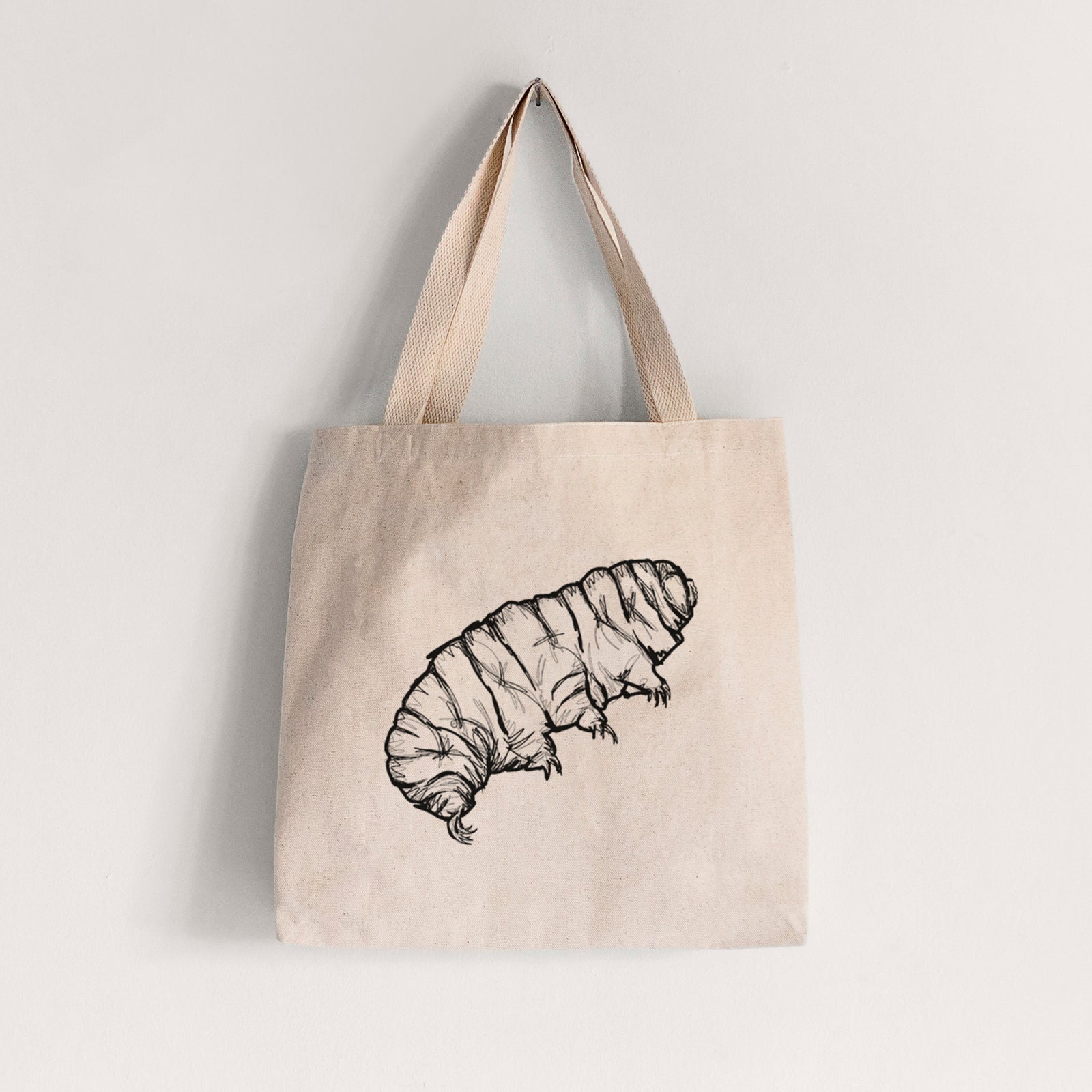 Natural canvas tote bag printed with a detailed black ink illustration of a tardigrade, or water bear.