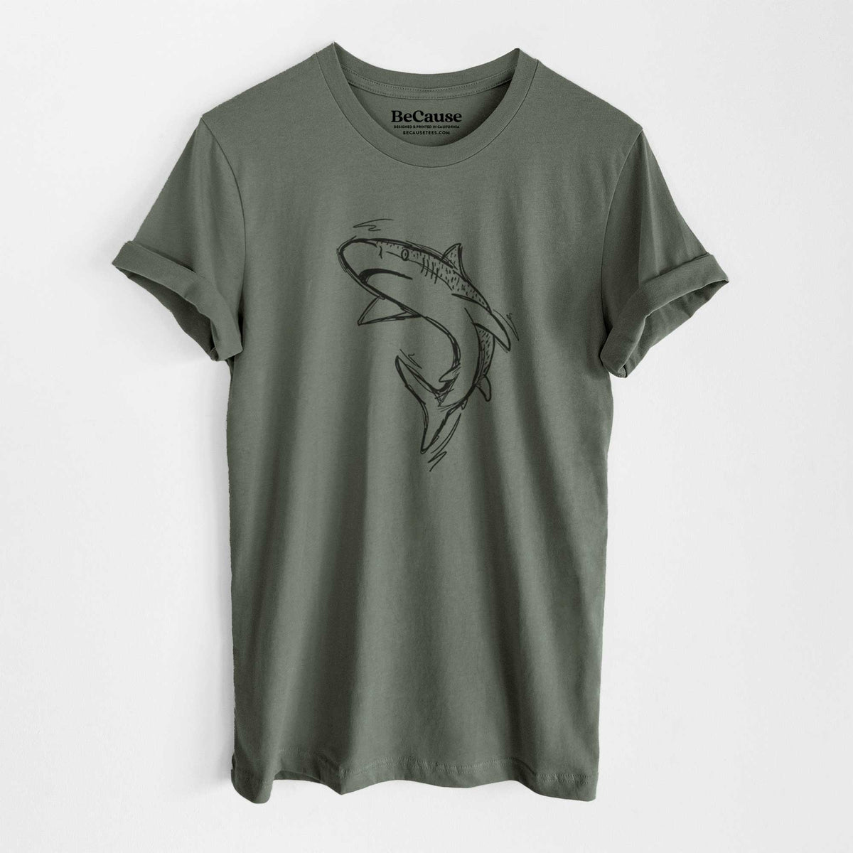 Military green lightweight cotton t-shirt laid flat, printed with a black ink illustration of a tiger shark swimming in a curve.