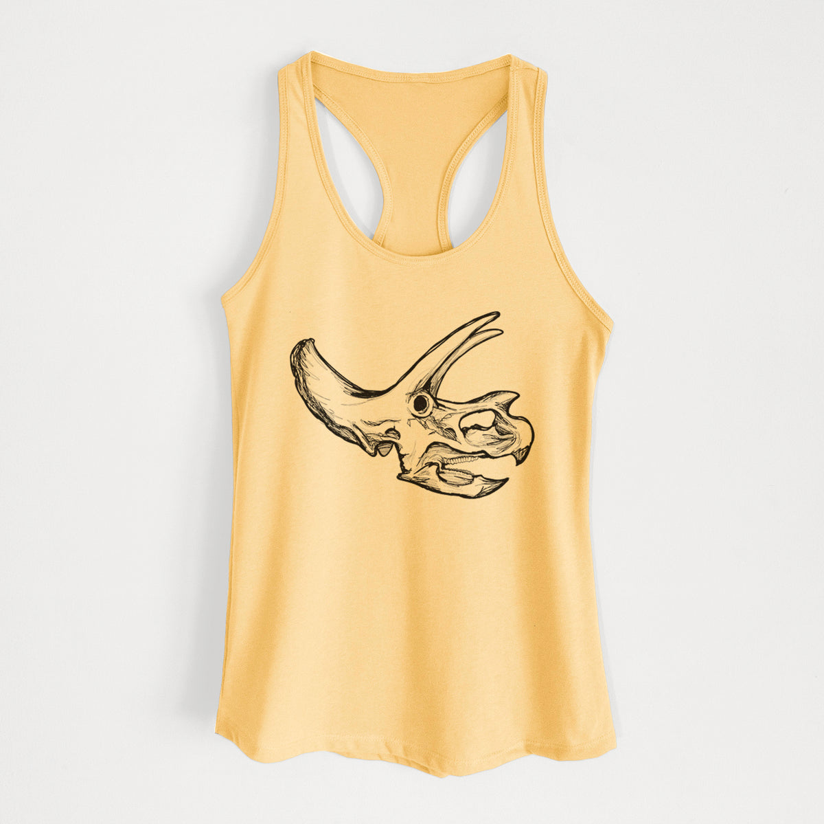 Banana cream women's racerback tank top laid flat, printed with a detailed black ink illustration of a Triceratops skull with its horns and frill.