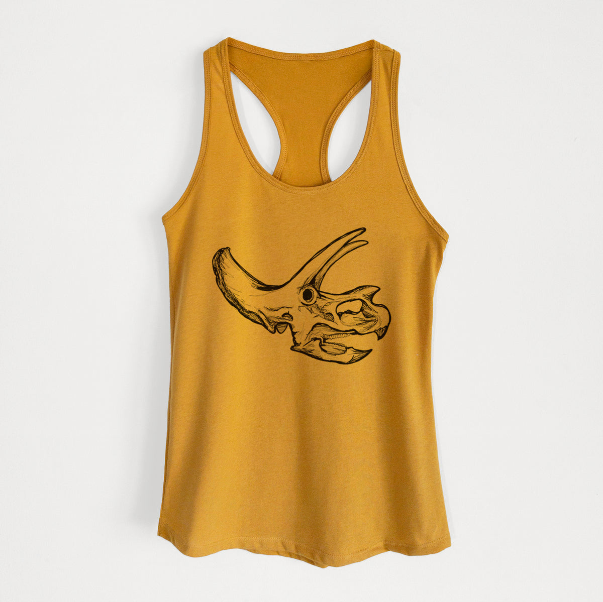Gold women's racerback tank top laid flat, printed with a detailed black ink illustration of a Triceratops skull with its horns and frill.