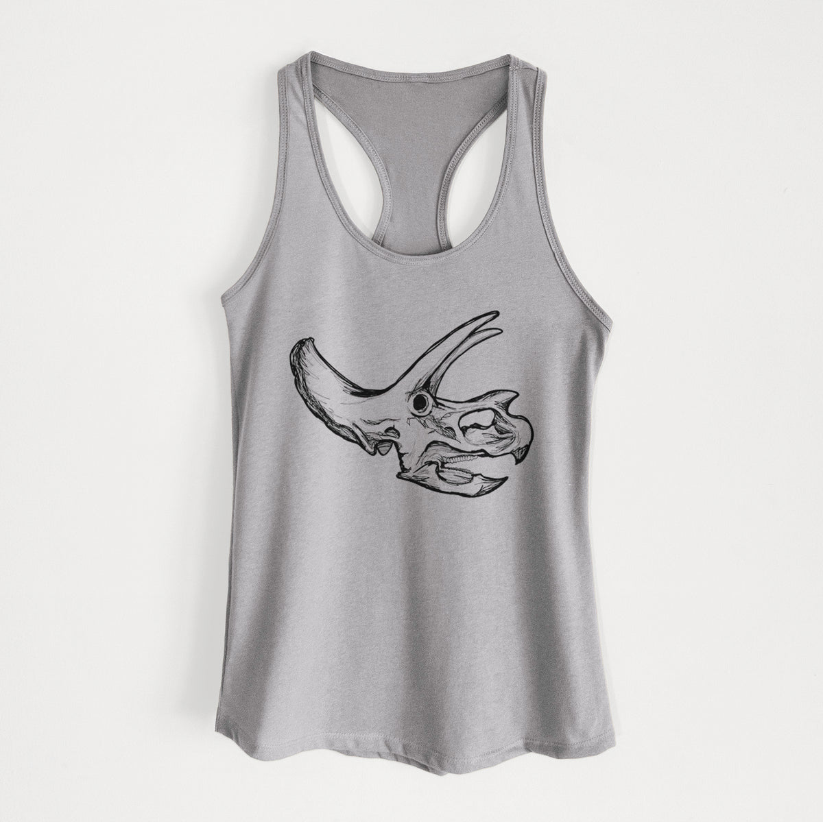 Heather grey women's racerback tank top laid flat, printed with a detailed black ink illustration of a Triceratops skull with its horns and frill.