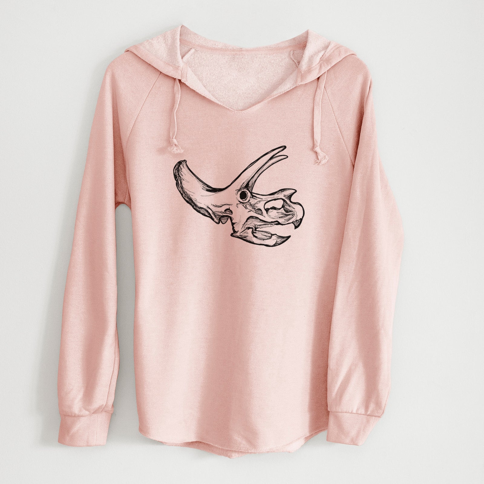 Sage green women's Cali Wave hooded sweatshirt laid flat, printed with a detailed black ink illustration of a Triceratops skull with its horns and frill.