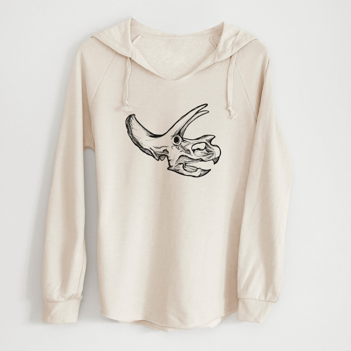 Bone cream women's Cali Wave hooded sweatshirt laid flat, printed with a detailed black ink illustration of a Triceratops skull with its horns and frill.