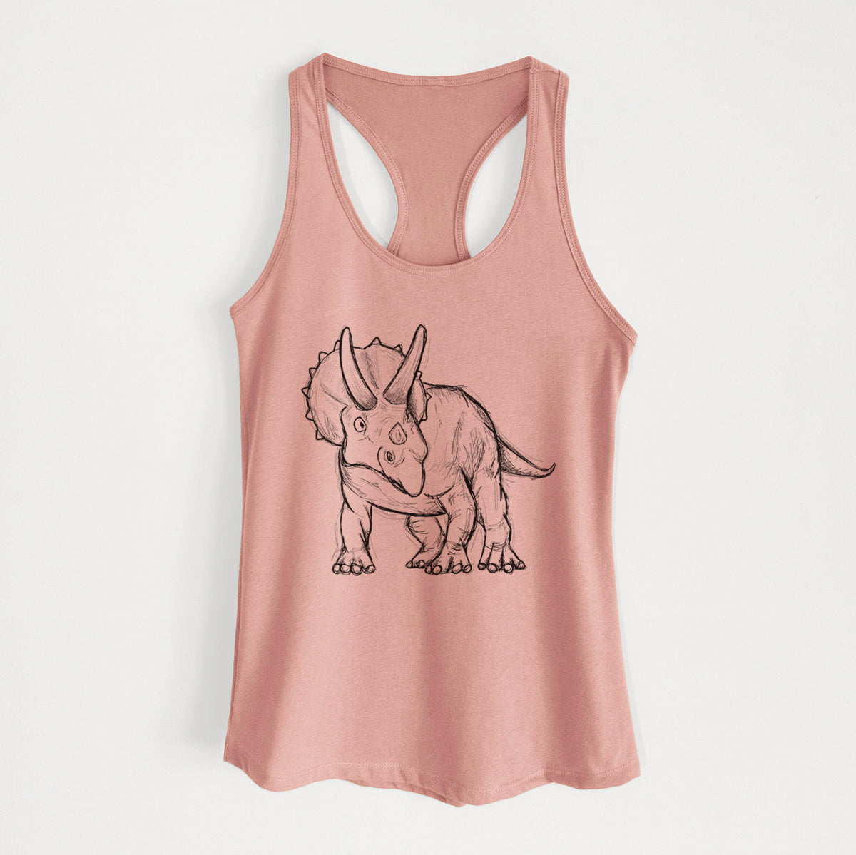 Desert pink women's racerback tank top laid flat, printed with a black ink illustration of a Triceratops walking.
