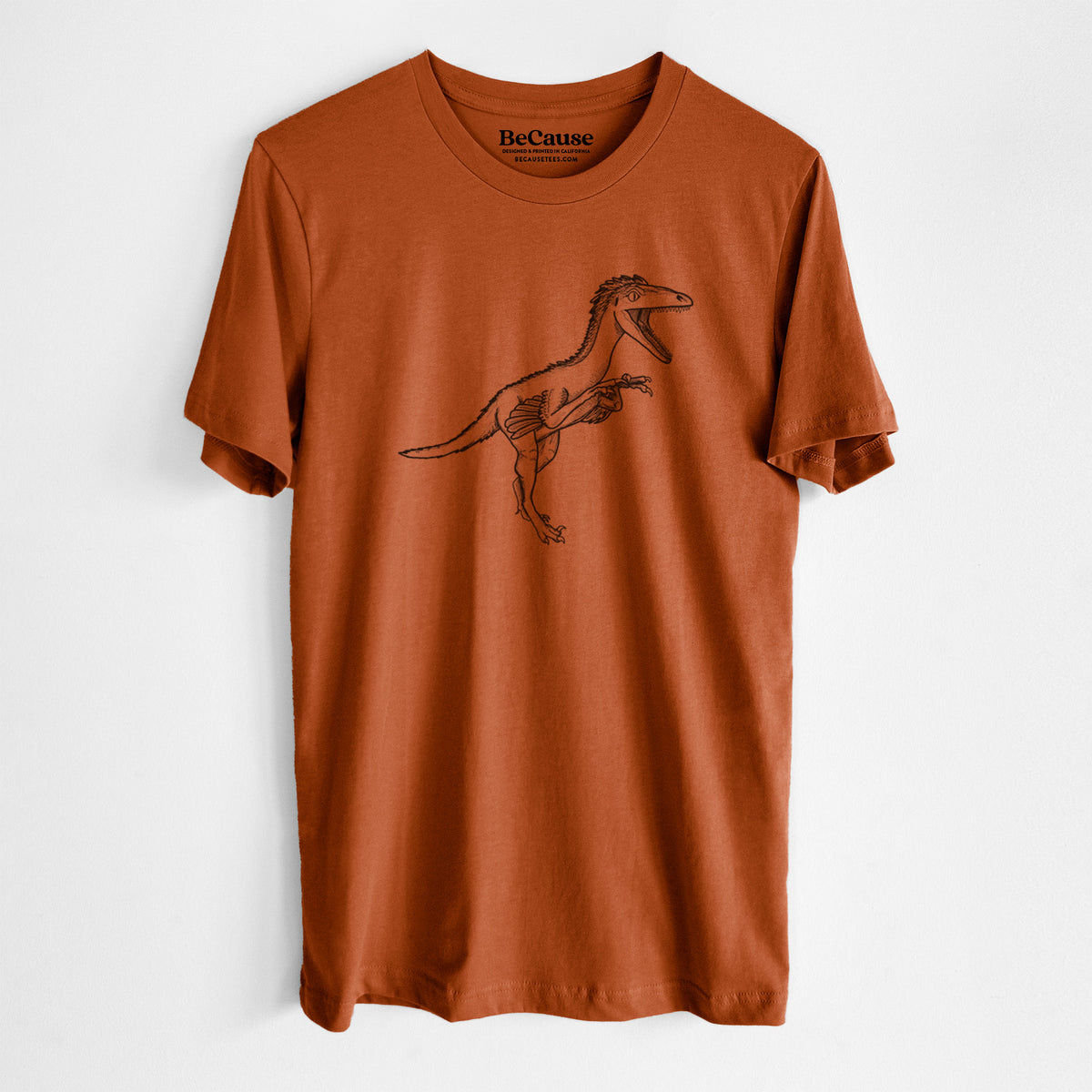 Autumn lightweight cotton t-shirt laid flat, printed with a black ink illustration of a Troodon dinosaur running.