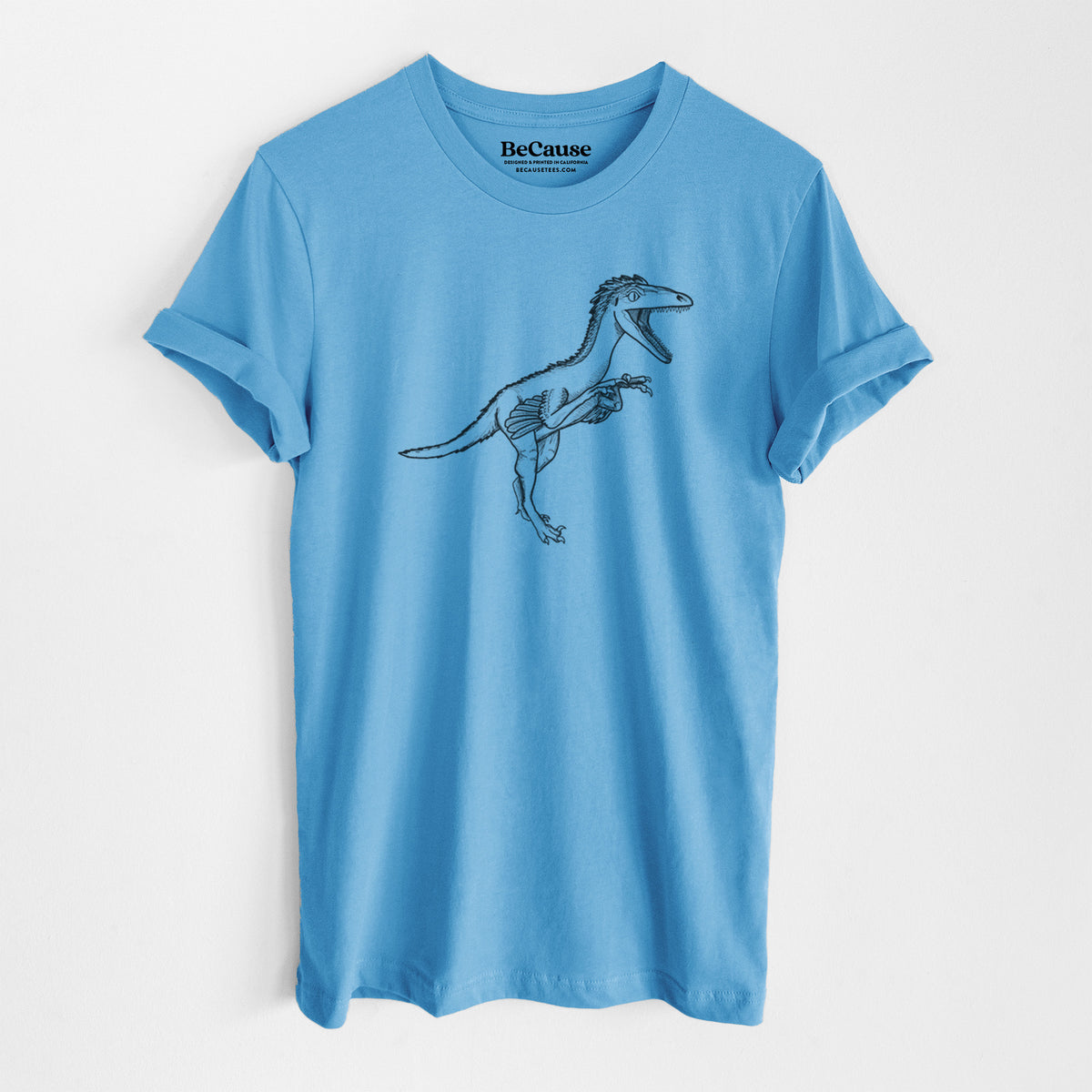 Ocean blue lightweight cotton t-shirt laid flat, printed with a black ink illustration of a Troodon dinosaur running.