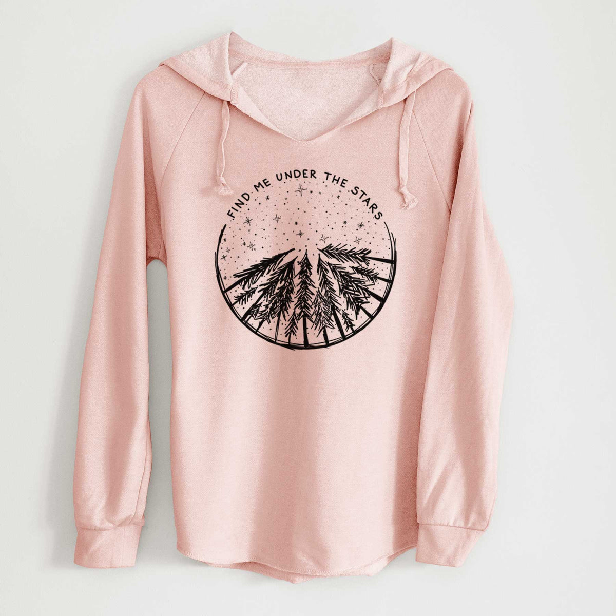 Blush pink women's Cali Wave hooded sweatshirt laid flat, printed with a circle of pine trees under a starry sky, with the words Find Me Under the Stars.