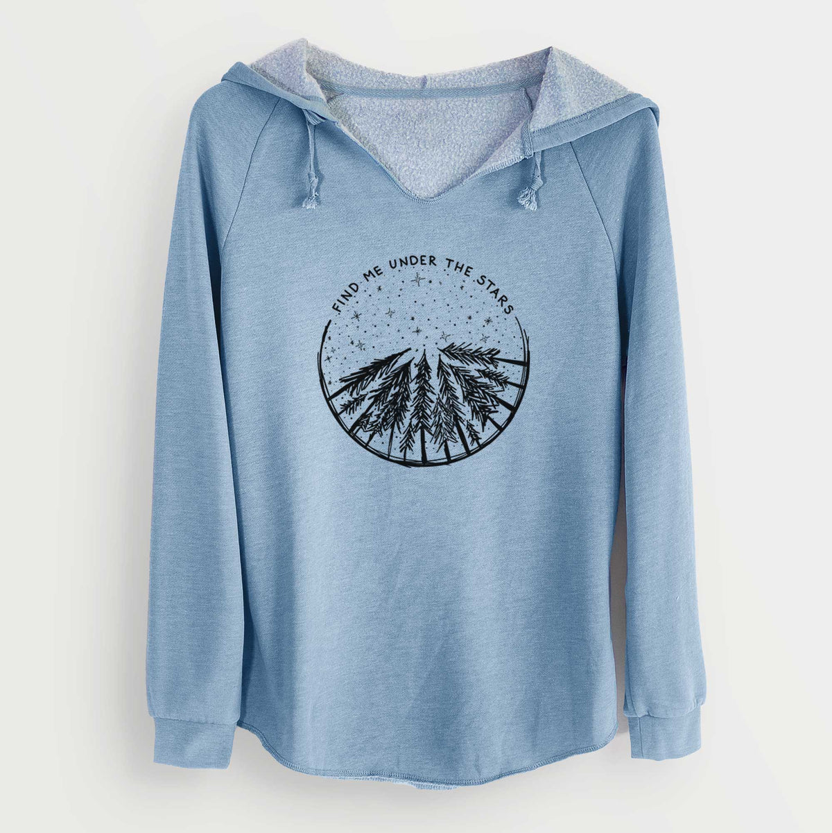 Misty blue women's Cali Wave hooded sweatshirt laid flat, printed with a circle of pine trees under a starry sky, with the words Find Me Under the Stars.