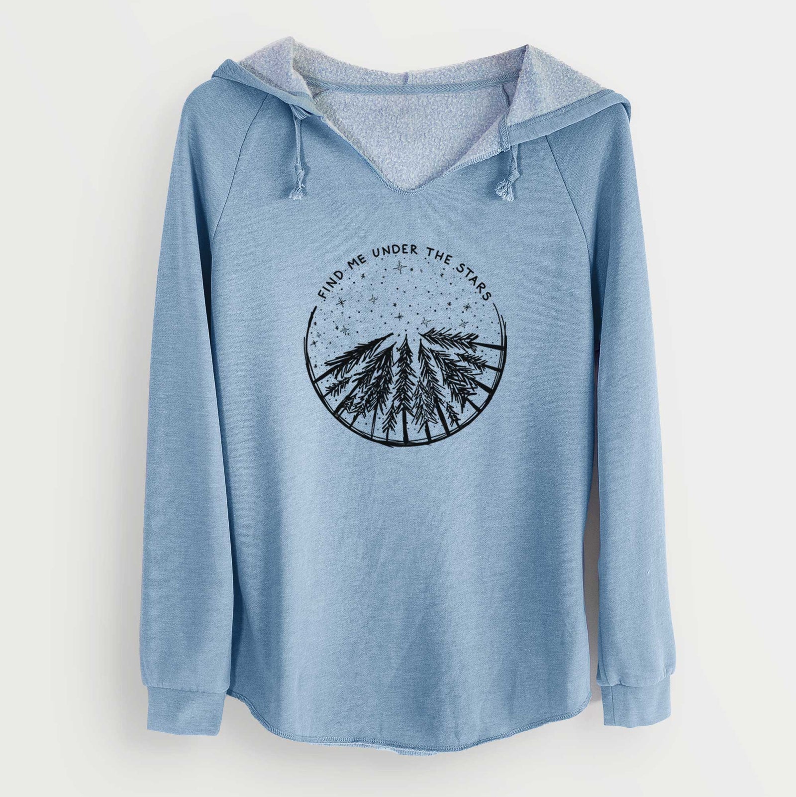 Misty blue women's Cali Wave hooded sweatshirt laid flat, printed with a circle of pine trees under a starry sky, with the words Find Me Under the Stars.