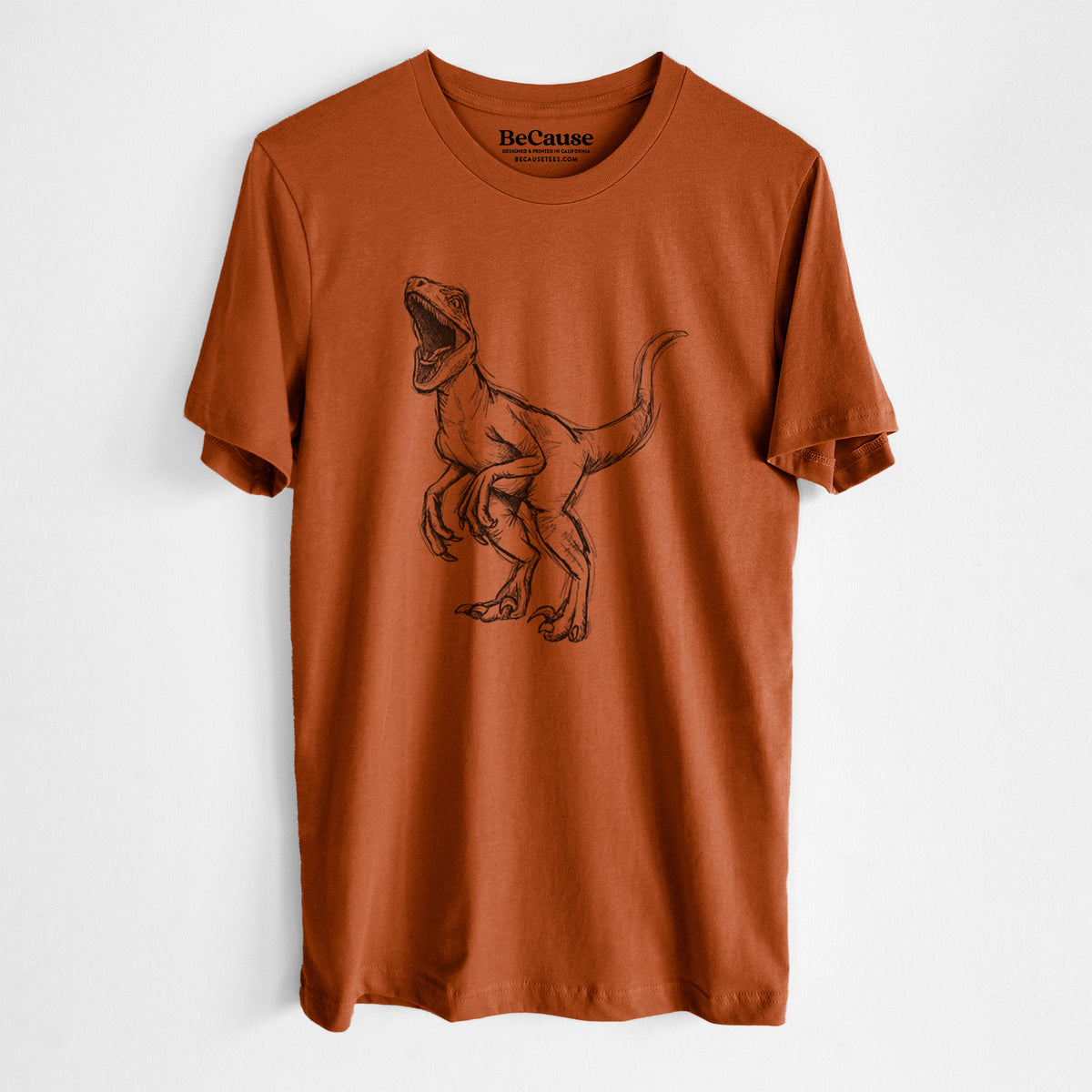 Autumn lightweight cotton t-shirt laid flat, printed with a black ink illustration of a Velociraptor roaring.