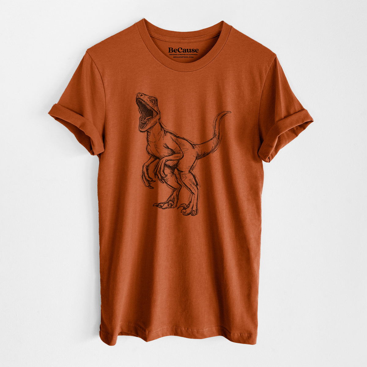 Autumn lightweight cotton t-shirt laid flat, printed with a black ink illustration of a Velociraptor roaring.