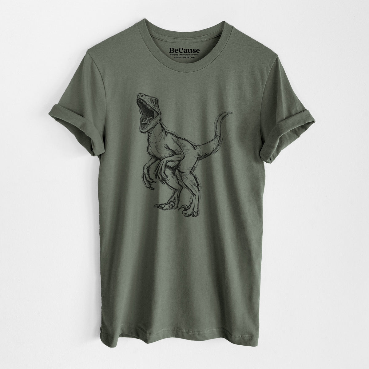 Military green lightweight cotton t-shirt laid flat, printed with a black ink illustration of a Velociraptor roaring.