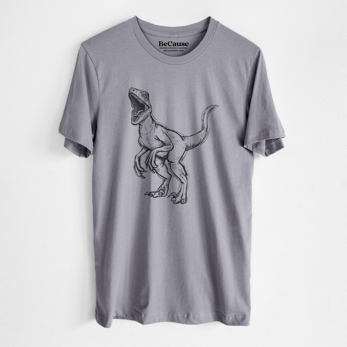 Storm grey lightweight cotton t-shirt laid flat, printed with a black ink illustration of a Velociraptor roaring.